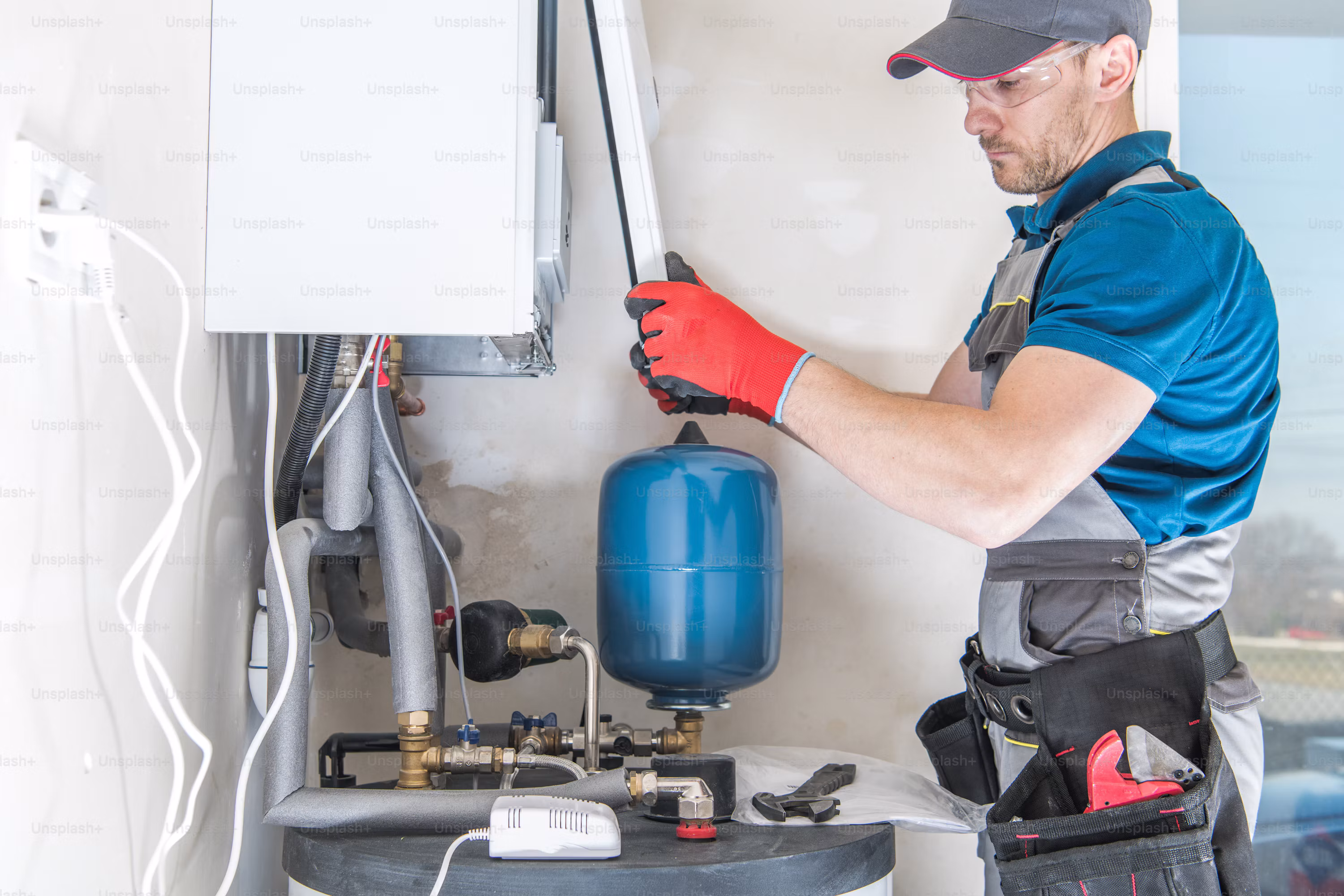 A technician servicing a home heating system