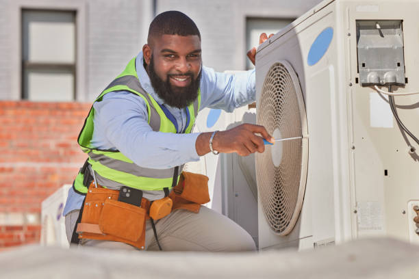 Illustrative photograph of a technician working on an outdoor air conditioning unit